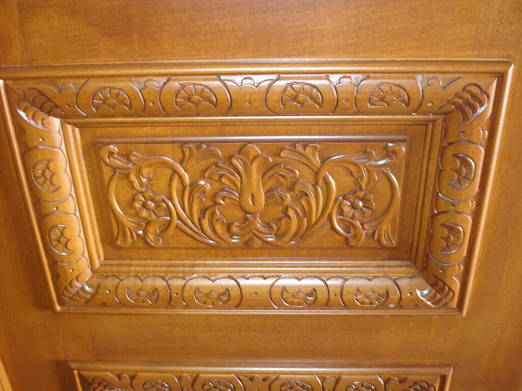 Close-up of a custom-carved front door